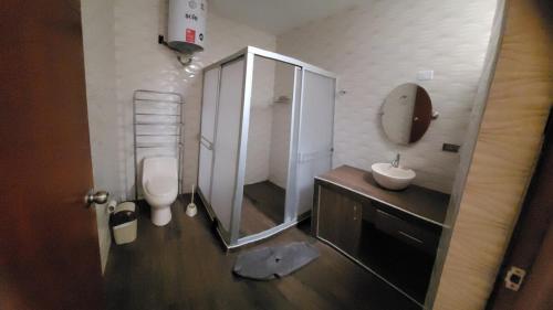 a bathroom with a shower and a toilet and a sink at Giovi's house in Ilo