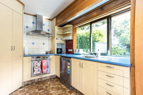 a kitchen with a sink and a stove at Spectacular LAKE View in Queenstown