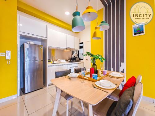 a kitchen and dining room with a wooden table and chairs at Pangsapuri Meridian by RR JBcity in Nusajaya