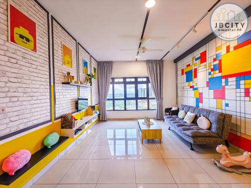 a living room with a couch and a table at Pangsapuri Meridian by RR JBcity in Nusajaya
