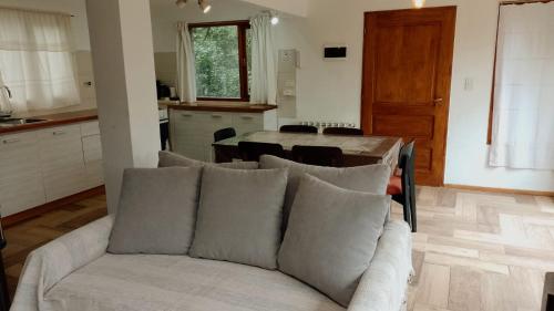 a living room with a couch and a table at Casa Tinta in San Carlos de Bariloche