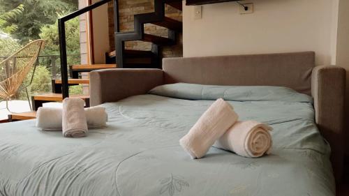 a bed with towels on it in a room at Casa Tinta in San Carlos de Bariloche