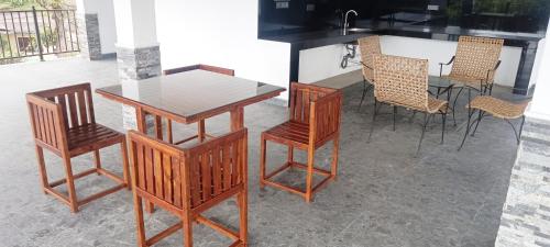 a table and four chairs and a table and a table at Johans Villa Kandy in Kandy