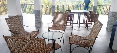 a group of chairs and a table in a room at Johans Villa Kandy in Kandy