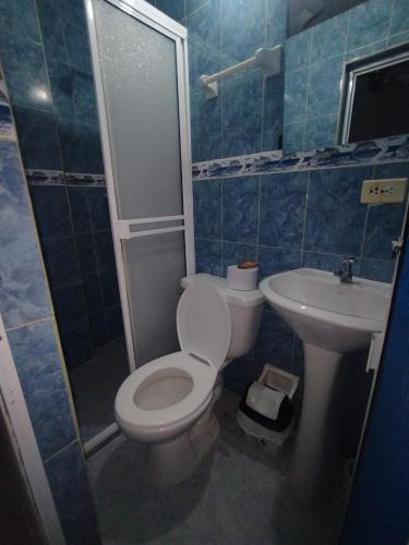 a bathroom with a toilet and a sink at La fantástica Mi Hostal in Cartagena de Indias
