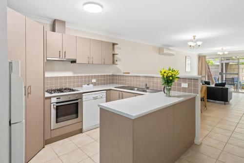 a kitchen with white appliances and a counter top at 20CapeView Geographe bay in Busselton