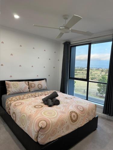 a bedroom with a bed with a teddy bear on it at This beautiful location in Rockbank