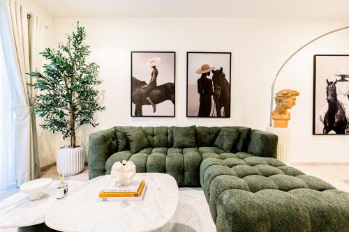 a living room with a green couch and a table at Fabulous 1BR in Dubai Marina near Beach With Sea Views in Dubai