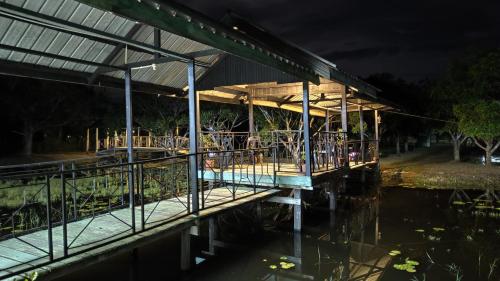 a building on the water at night at FZ Tuaran Country Village in Tuaran