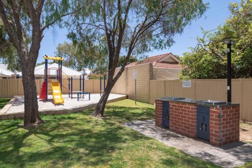 a playground with a slide in a yard at 5@CapeView, beachfront Geographe Bay in Busselton