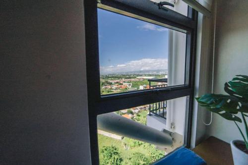 a window with a view of a city at JYL Royal Oceancrest Mactan Condo Staycation in Mactan Island