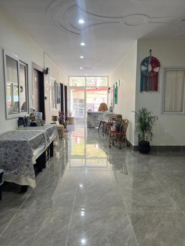 a large room with tables and chairs in a room at Blissful stays midst nature in Rishīkesh