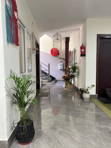 a hallway with potted plants in a building at Blissful stays midst nature in Rishīkesh
