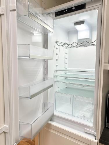 an empty refrigerator with its door open at Luxury home in prime location Steps from WoodGreen in London