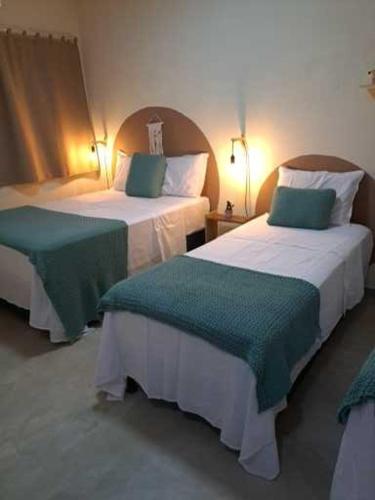 Postel nebo postele na pokoji v ubytování Bangalôs Vila do Arraial