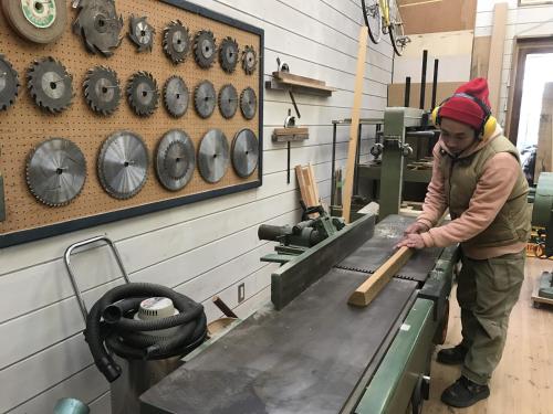 a woman is working on a machine in a shop at Mt Fuji Historical Oshi house hitsuki in Fujiyoshida