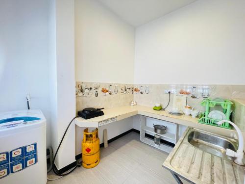 a small kitchen with a counter and a sink at Emerald Villa in Matara