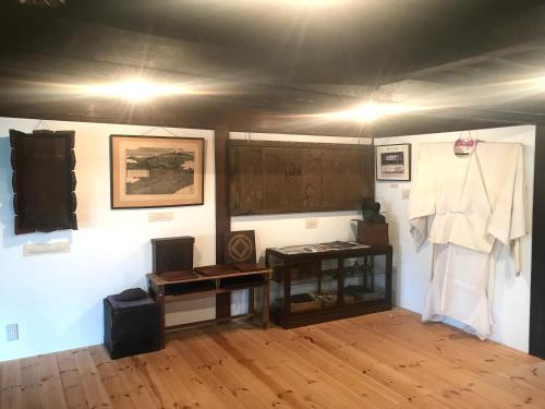 a room with a table and a chalkboard on a wall at Mt Fuji Historical Oshi house hitsuki in Fujiyoshida