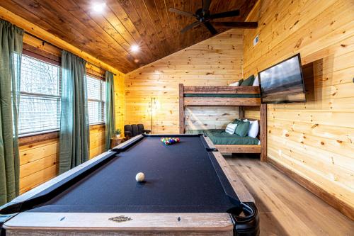 a pool table in a room with wooden walls at Cozy Mountaintop Cabin with Firepit, HotTub & Views! in Sevierville