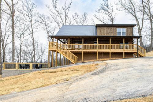 a large house on top of a hill at Cozy Mountaintop Cabin with Firepit, HotTub & Views! in Sevierville