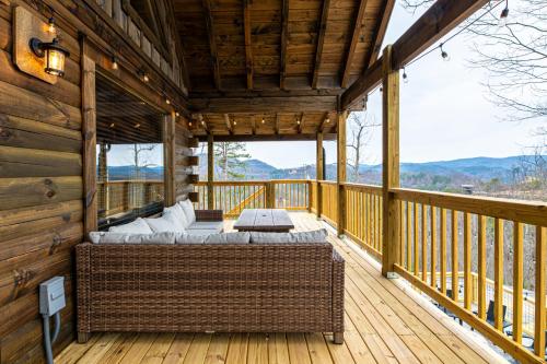 a bed on the deck of a cabin at Cozy Mountaintop Cabin with Firepit, HotTub & Views! in Sevierville
