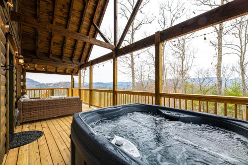 a jacuzzi tub on a wooden deck at Cozy Mountaintop Cabin with Firepit, HotTub & Views! in Sevierville
