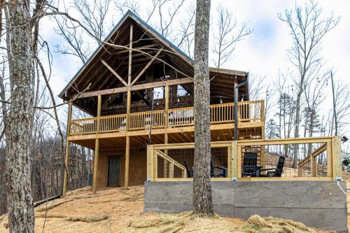 a house in the middle of the woods at Cozy Mountaintop Cabin with Firepit, HotTub & Views! in Sevierville
