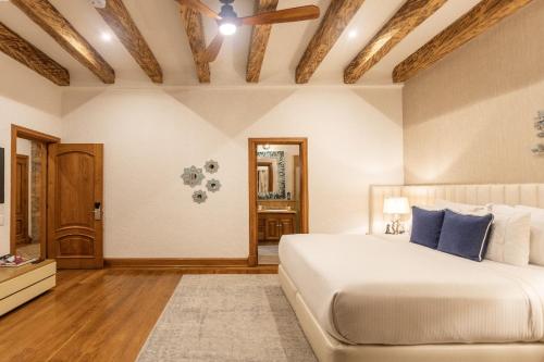 a bedroom with a large bed with blue pillows at Visus Hotel Boutique & Spa in Pereira