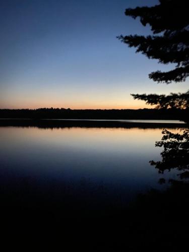 a view of a lake at sunset at Blue Spruce Bed and Breakfast Muskoka in Gravenhurst