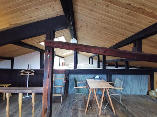 a dining room with a wooden table and chairs at Mt Fuji Historical Oshi house hitsuki in Fujiyoshida