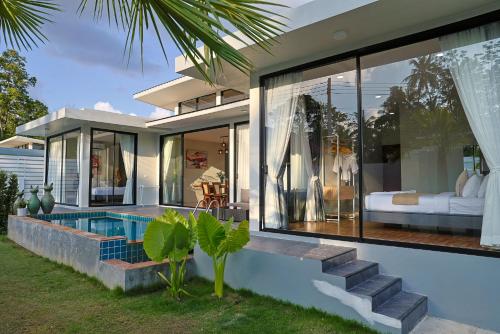 a house with a swimming pool in the backyard at Villa Luna Mara in Koh Phangan