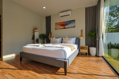 a bedroom with a large bed in a room at Villa Luna Mara in Koh Phangan
