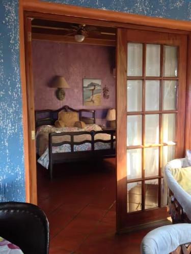 a room with a bedroom with two beds and a mirror at Casa de Arena in Manzanillo