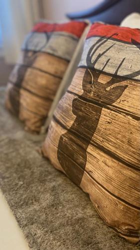a row of oldenen cushions sitting on the floor at Blue Spruce Bed and Breakfast Muskoka in Gravenhurst