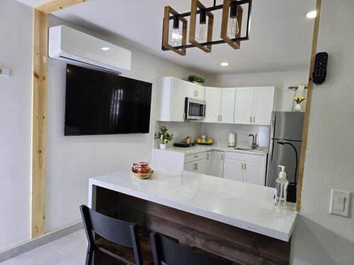 a kitchen with white cabinets and a white counter top at Apartment in Las Vegas