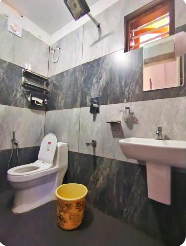 a bathroom with a toilet and a sink at Premium 4 Bedroom Villa in Kannur in Edakkād