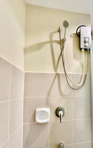 a bathroom with a shower with a toilet at Avida Towers Aspira Tower 1 in Cagayan de Oro
