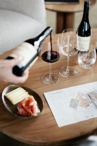 a person pouring wine into wine glasses on a table at Nest & Nature in Inman Valley