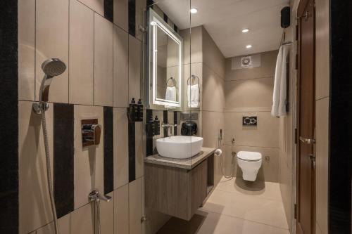 a bathroom with a sink and a toilet at Echor Noah Villa Tirthan Valley in Gushaini