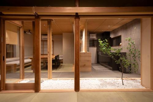 a glass door of a house with a living room at プライベートリゾート竹泉 in Atami