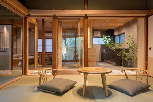 a living room with a table and two chairs at プライベートリゾート竹泉 in Atami