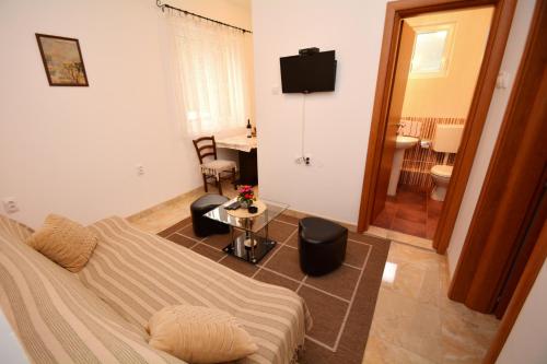 a living room with a couch and a table at Marinero Apartments in Kotor