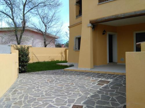 a house with a stone walkway in front of a yard at Casa Marina Maria in Murta Maria