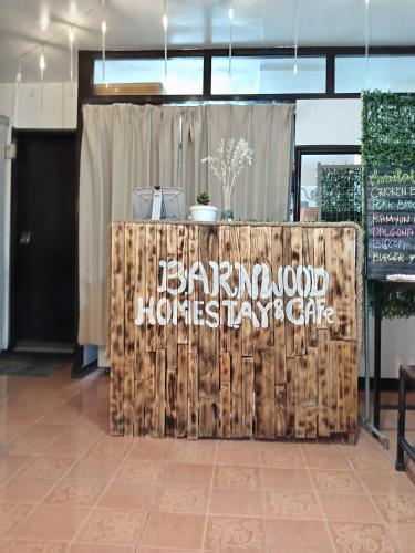 a sign for a barrington wood housekeepers day care at Barnwood Homestay&cafe in Banaue
