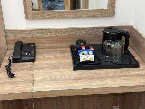 a tray with a coffee maker and a phone on a counter at The Royal Metropolitan IGI Airport Delhi in New Delhi