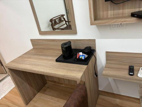 a desk in a room with a camera on it at The Royal Metropolitan IGI Airport Delhi in New Delhi