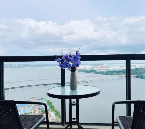 a table with a vase of flowers on a balcony at R&F Seine Region in Johor Bahru
