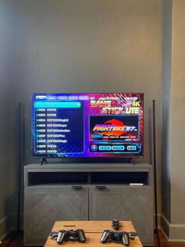 a television with two video game controllers in front of it at Near Hershey, Entire house with Fire Pit, Game Room in Middletown