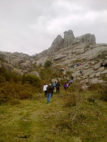 a group of people walking on a hill at Gerês Guest House in Geres