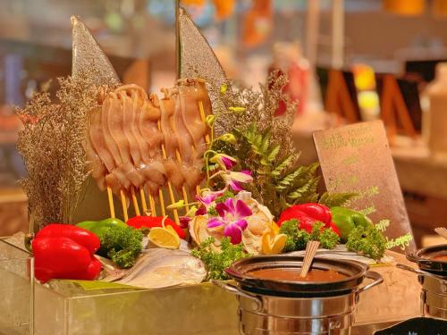 a tray of food with meat and vegetables on a table at Gran Melia Xi'an in Xi'an